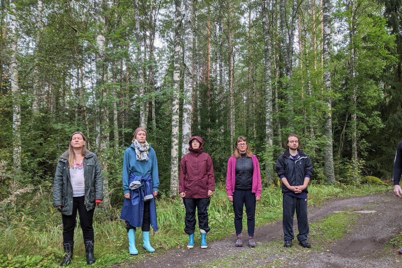 five people standing in the woods in orivesi, finland